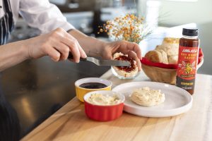 Buttermilk Biscuits with Sneaker Green Jalapeño Hot Honey Sauce, Butter, and Scorpion Raspberry Pepper Jam