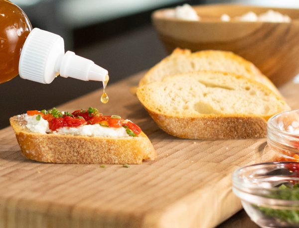 Whipped Feta Cheese Crostini with Little BEEst Pineapple Habanero Hot Honey Sauce